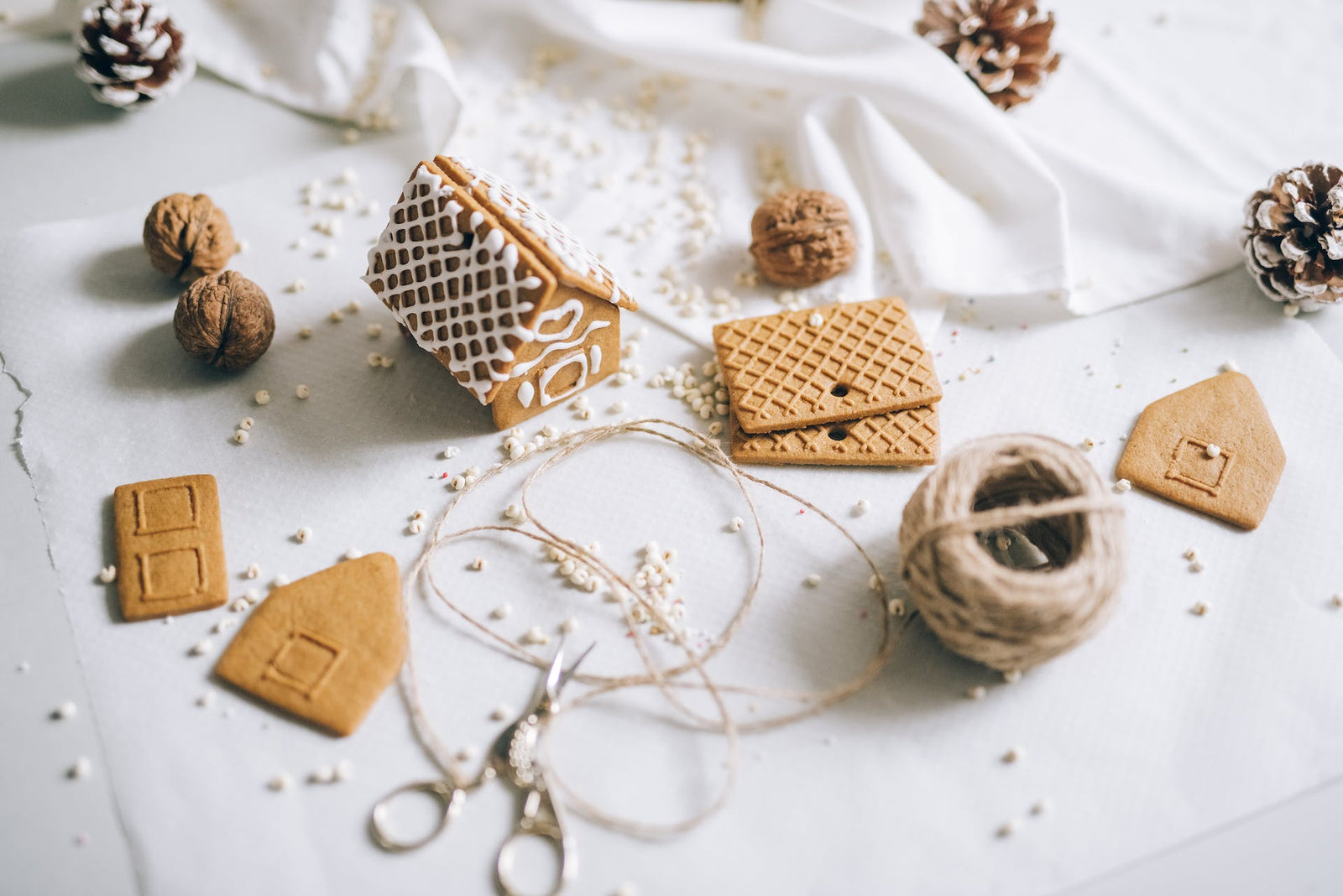 Gingerbread, beads, and twine on a table.