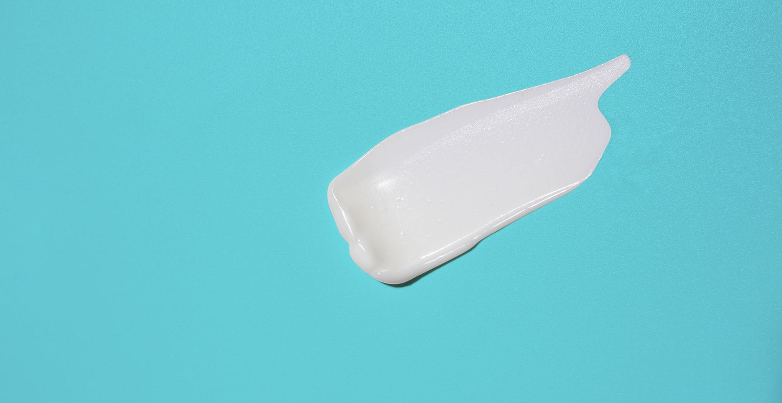 Swipe of adult barrier cream on a blue background