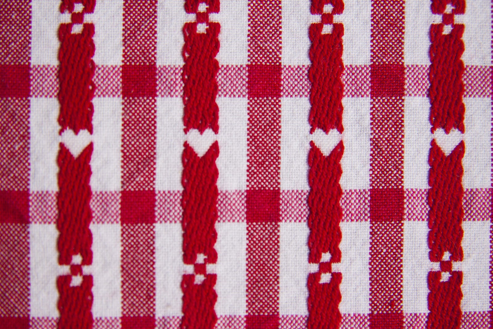 A close up of red and white stitched fabric