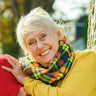 Woman leaning on husband and posing for picture.