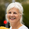 A woman smiles happily.