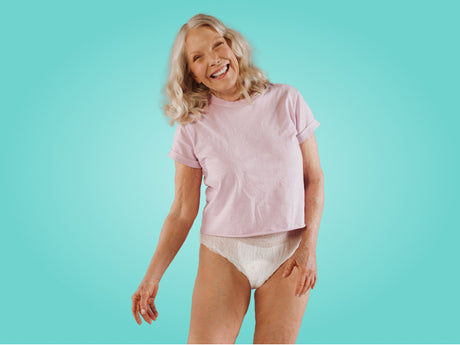A woman in a pink shirt and protective underwear.