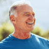 A man outside smiling.