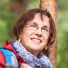 A woman smiling outdoors.