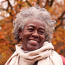 A woman in a scarf poses.
