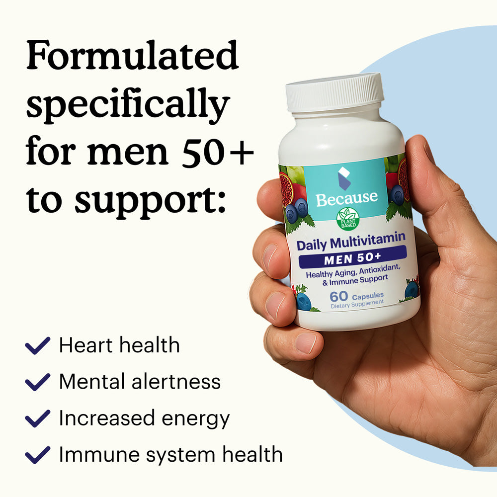 Hand holding a bottle of 'Because' Daily Multivitamin MEN 50+ with text highlighting benefits on a light blue background.