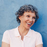 A woman leaning against a wall.