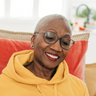 A woman in an orange sweatshirt.