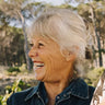 A woman smiling with friends outside.