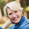 A woman posing for a picture and smiling.