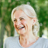 A woman laughs for a photo.
