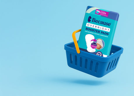 Because Overnight Booster Pads package in blue shopping basket with yellow handle on a light blue background