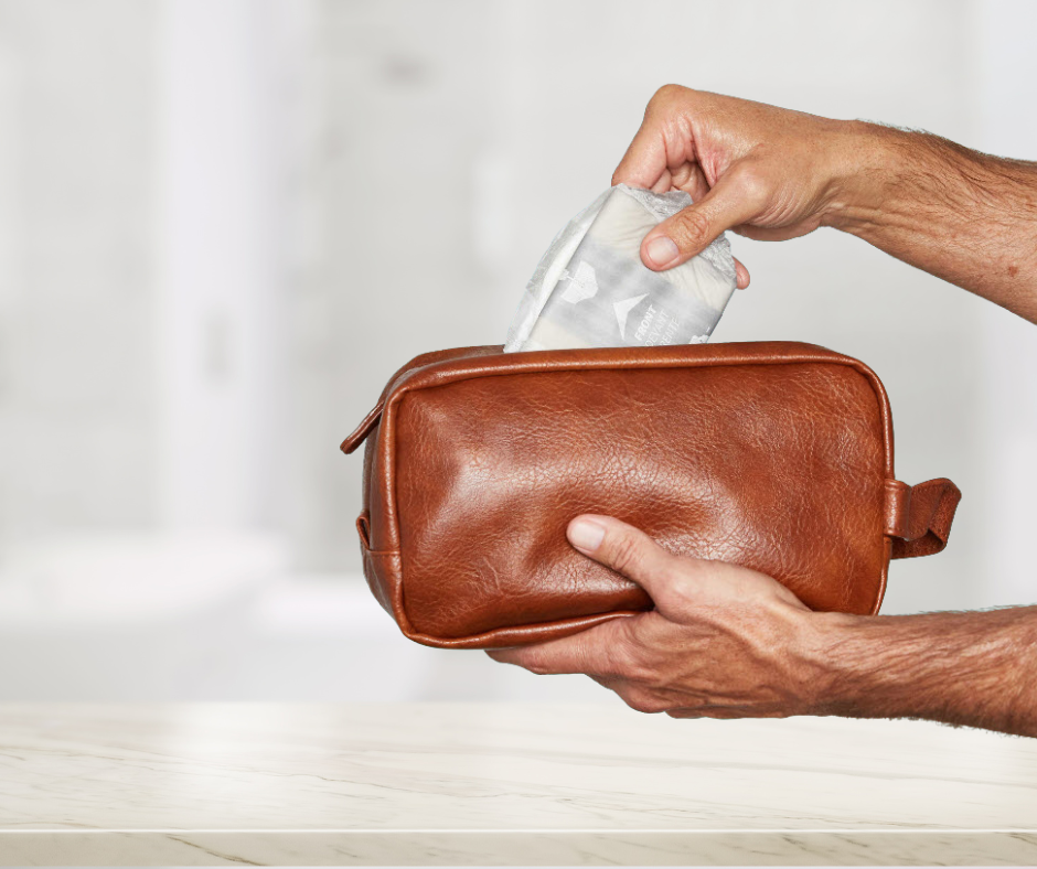 Pair of hands holding a leather bag and retrieving a pad from its contents