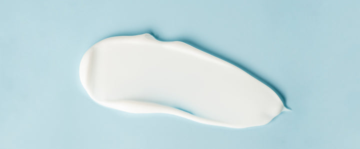 Cosmetic cream on blue background, close up