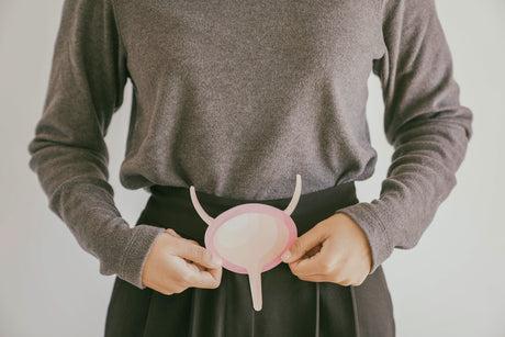A person holds a paper cutout of a bladder.