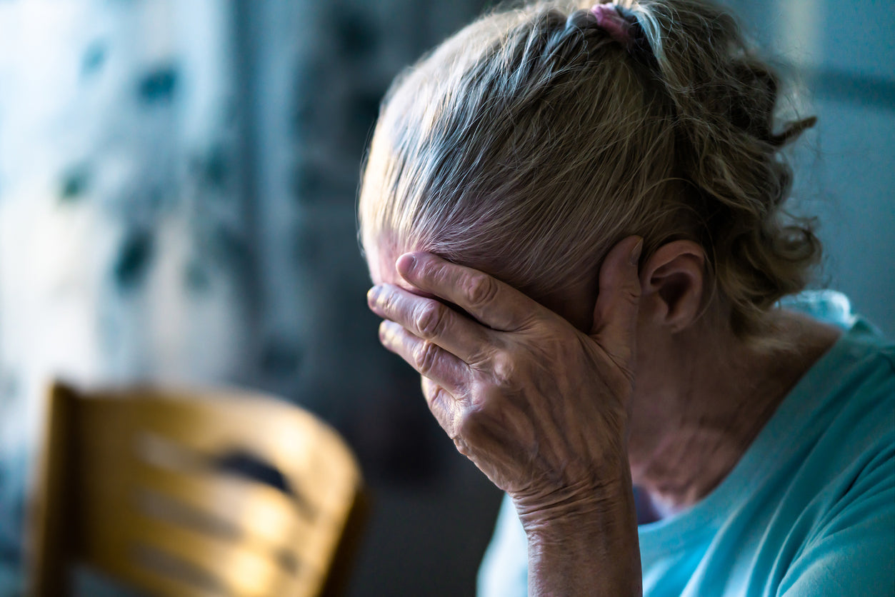 A woman with her head in her hand.