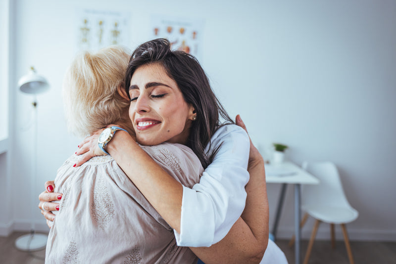 A doctor and patient hug.