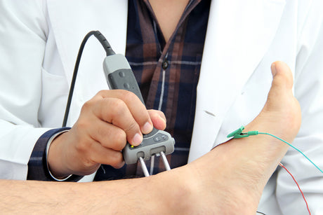 A doctor tests the nerve function in a patients ankle.