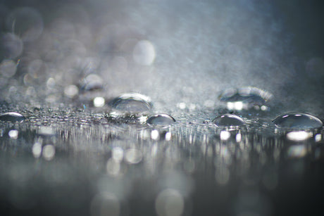 Abstract composition water drop on stainless surface, bokeh light