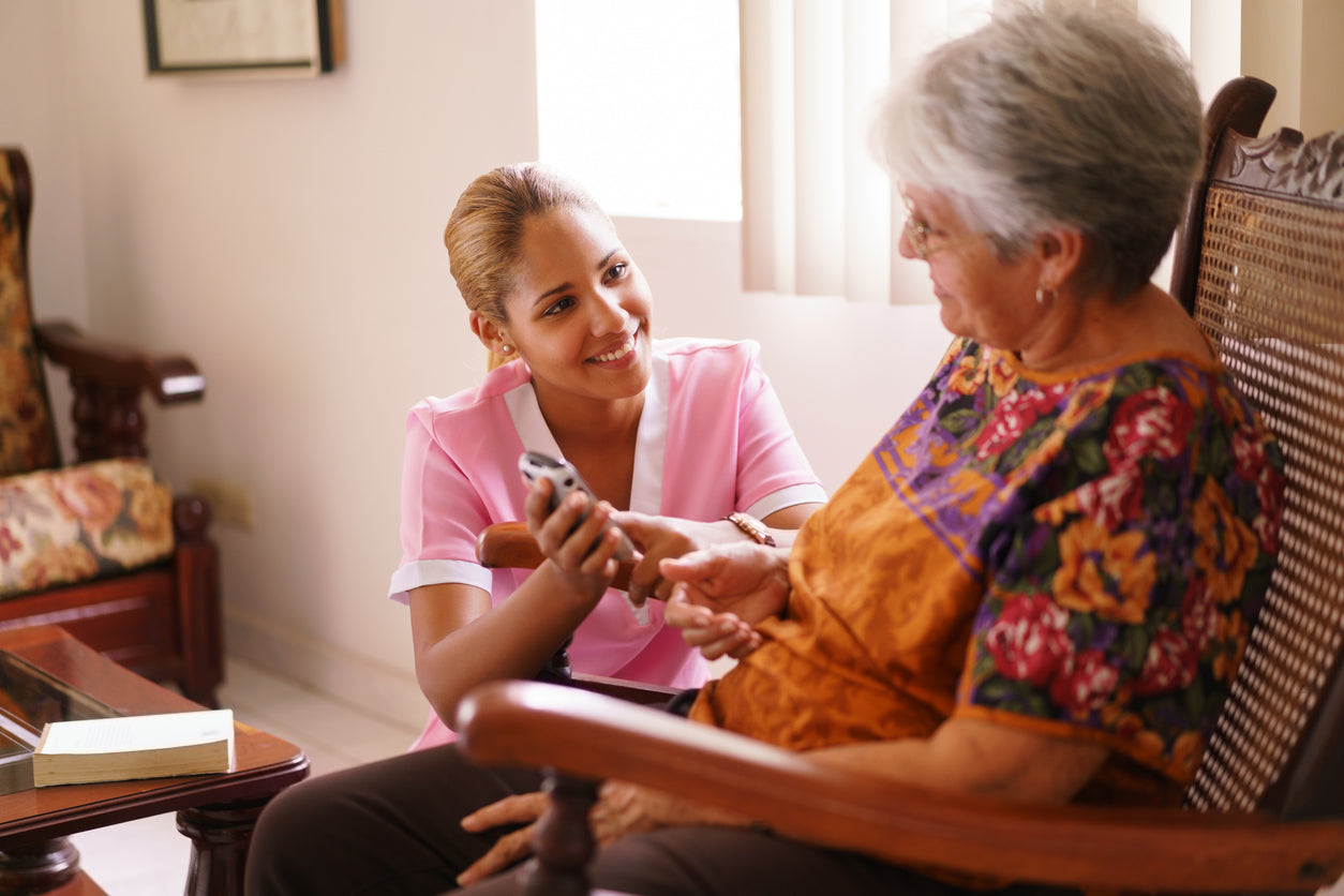 A caregiver and patient smiling.