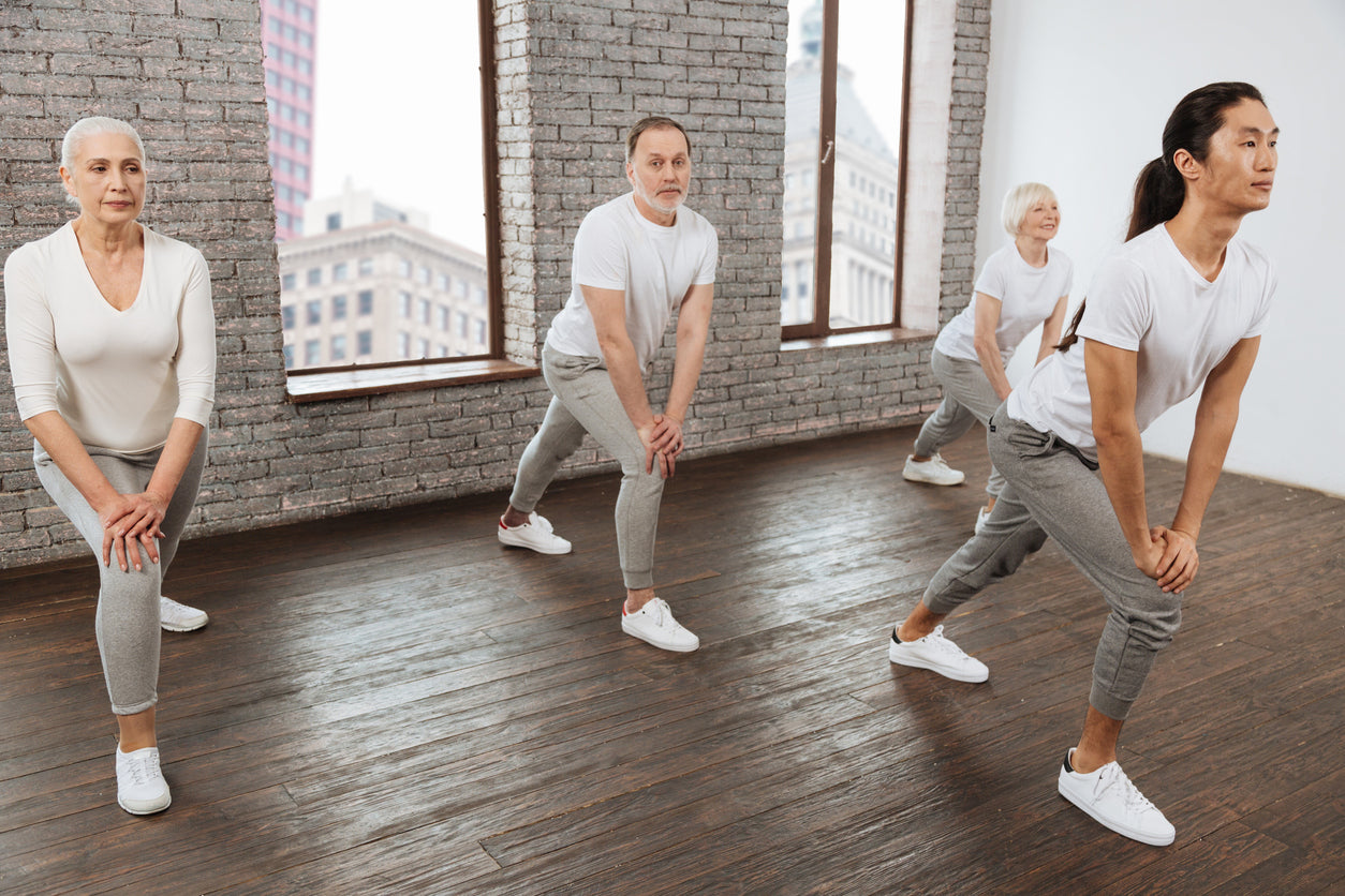 Older adults doing yoga in a studio