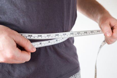 A man measuring his waist.