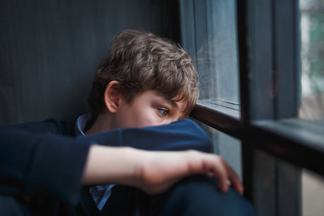 A young boy looking sad.