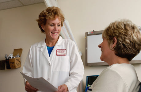 A urologist discusses treatment with a patient.