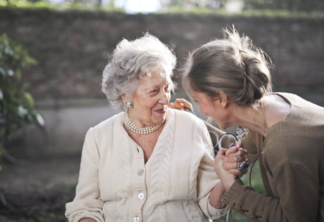 A young woman talks to an elderly woman.