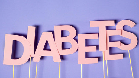 The word "diabetes" is spelled out on paper letters held on thin sticks.