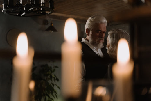 A couple slow dances in the dark room illuminated by candles.