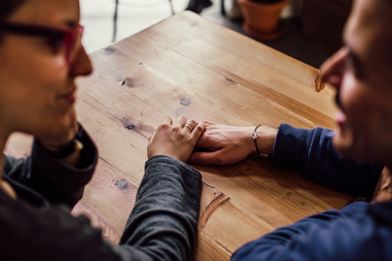 A person holding another person's hand in support.