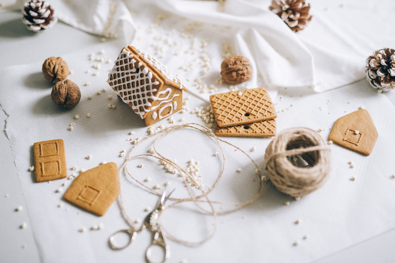 Gingerbread, beads, and twine on a table.