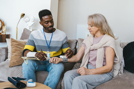 A man takes a woman's blood pressure.