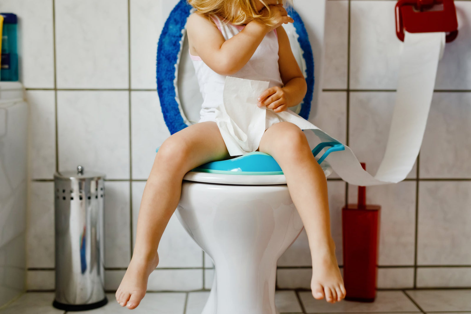 Young child sitting on a toilet as she learns to use the toilet