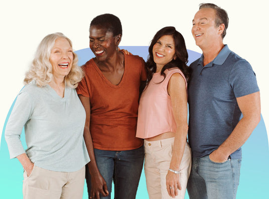 A group of adults poses together laughing.
