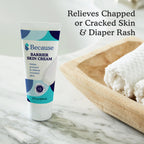 Bottle of Because Barrier Skin Cream on marble surface with text "relieves chapped or cracked skin & diaper rash."