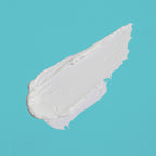 White cream swatch on a teal background
