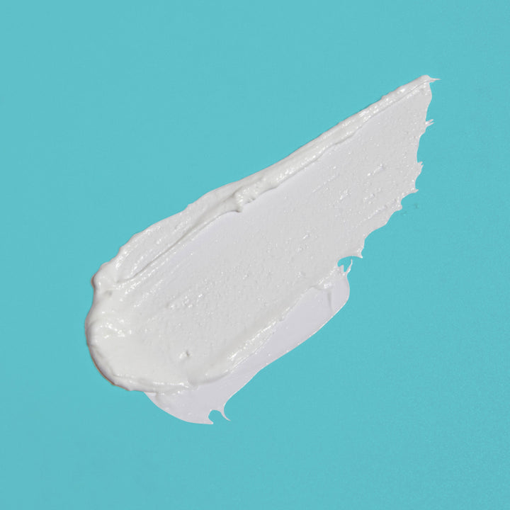 White cream swatch on a teal background