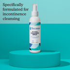 No-rinse cleansing spray bottle on a teal platform with a light blue background including text "formulated for incontinence cleansing"