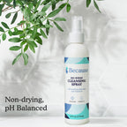 Bottle of 'Because' no-rinse cleansing spray with green leaves in the background including text "non-drying pH balanced"