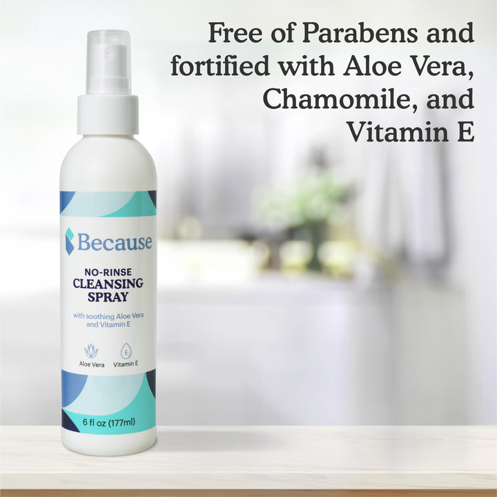 Bottle of Because no-rinse cleansing spray on white ledge with text "Free of parabens and fortified with Aloe vera, chamomile, and vitamin E."