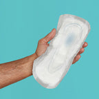Hand holding Because men's premium guard on teal background.