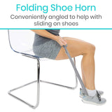 A folding shoe horn to slide on shoes with ease.
