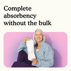 Woman holding a Because moderate bladder control pad with text "Complete absorbency without the bulk" on a white and pink background.