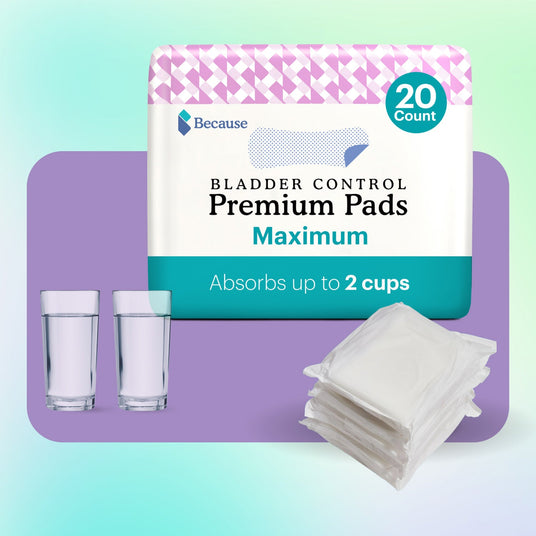 A package of Because Market Premium Maximum Pads and two cups of liquid to demonstrate absorbency.