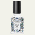 Poo-Pourri bottle with decorative label on a white background