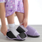 Model putting on Silverts Women's Extra-Wide Easy Closure Slippers in purple on white background