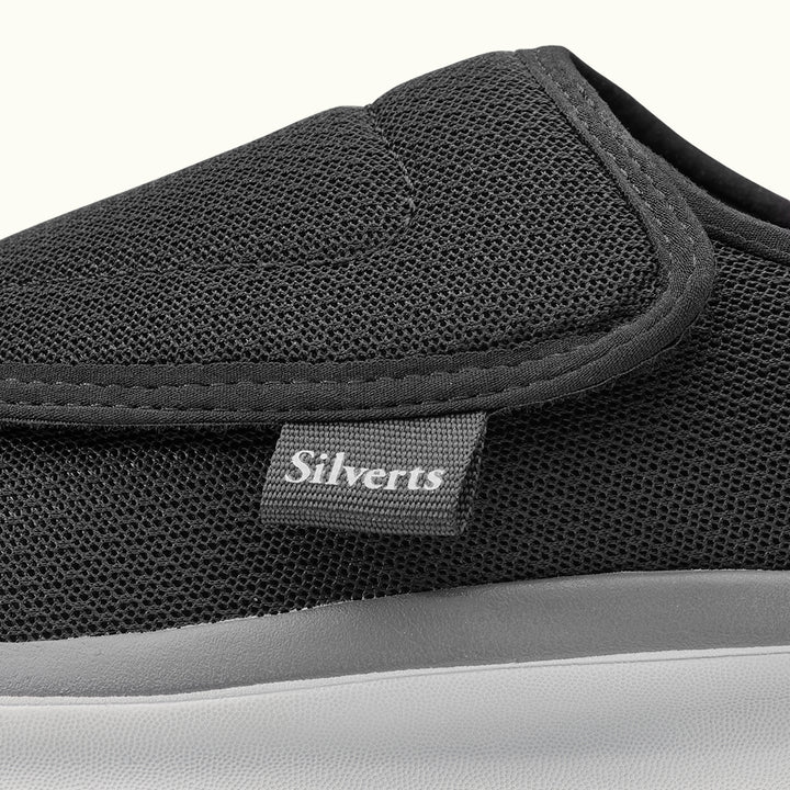 Up close view of Black Women's Extra Wide Comfort Shoes with gray soles on a white background
