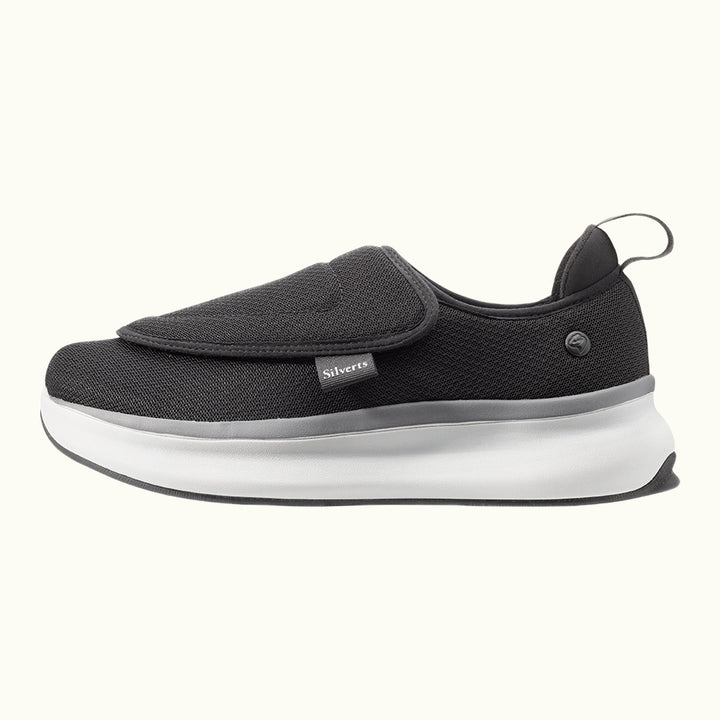 Side view of Black Men's Extra Wide Comfort Shoes with gray and white soles on a white background